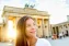 Young lady facing sunlight in front of the Brandenburg Gate in Berlin